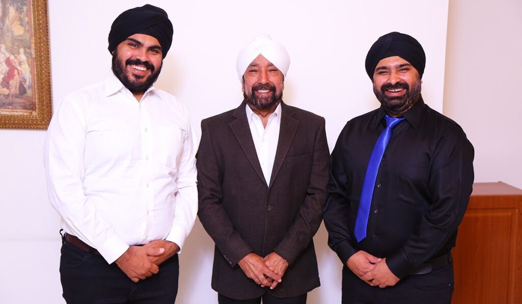 A photgraph of Mr Surjit Singh, Mr. Guneet Singh, and MR. Sanjeet Singh posing together for a group photograph